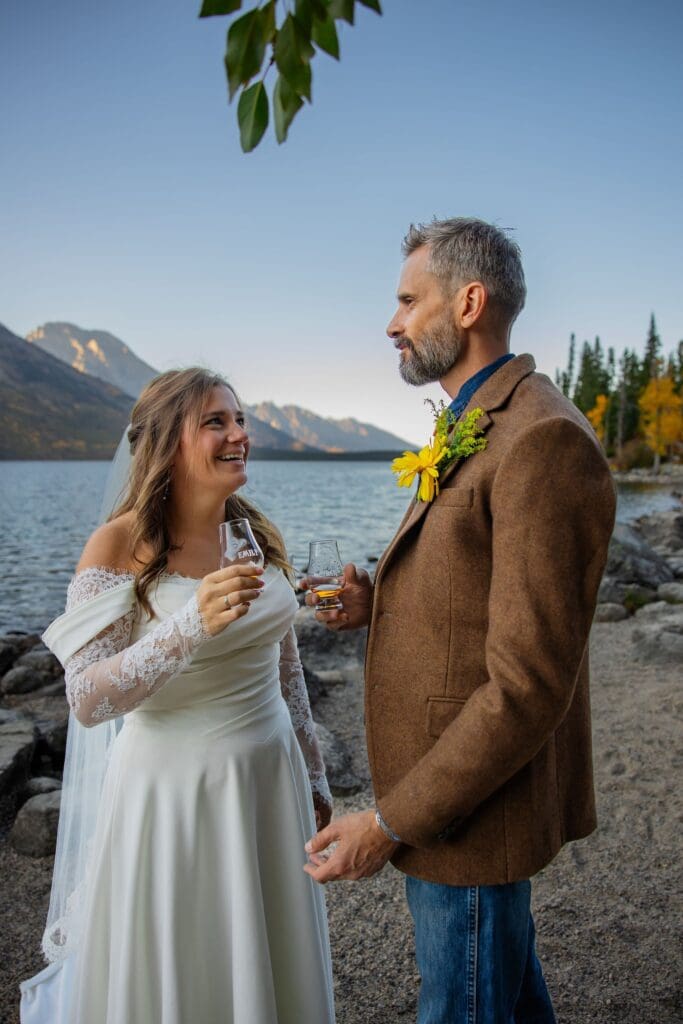 Couple laughs together as they share their favorite drink