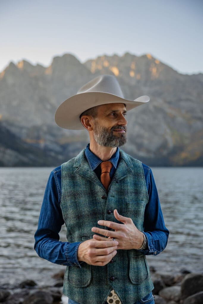 groom poses in western attire