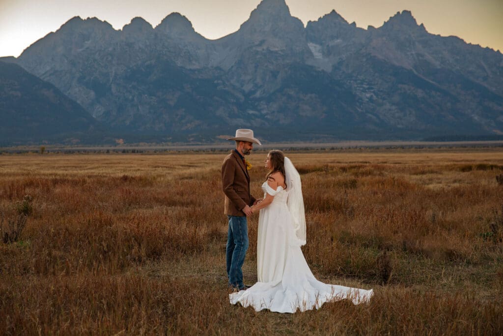 Bride and Groom share a romantic moment in front of the Grand Tetons