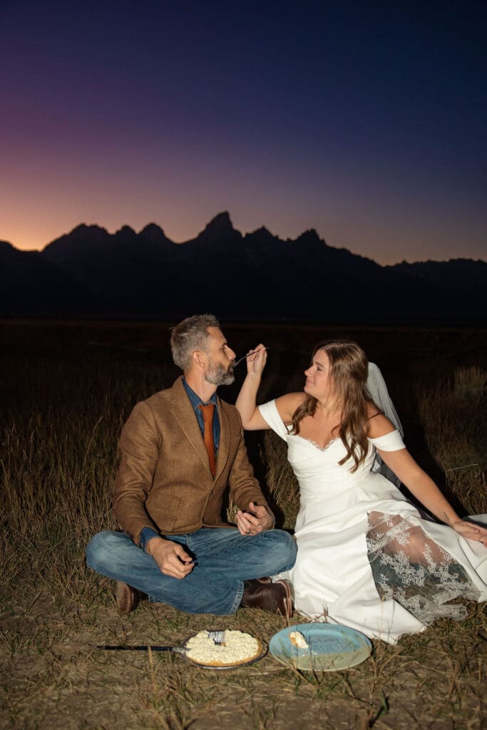 wife feeds husband wedding cake