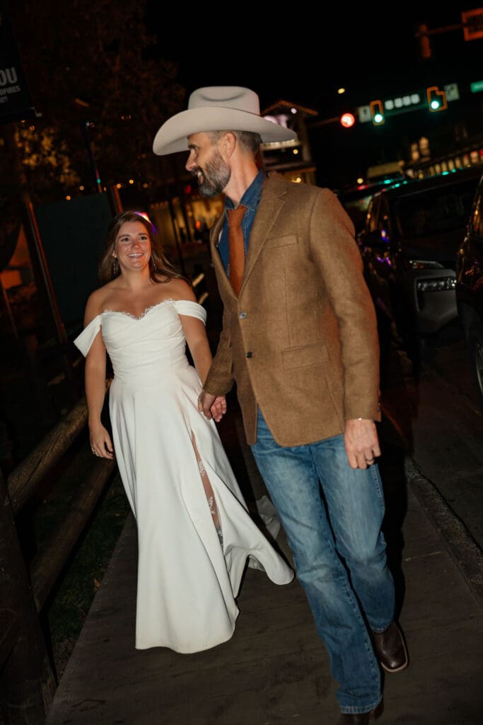 husband leads wife through downtown Jackson Hole, Wyoming