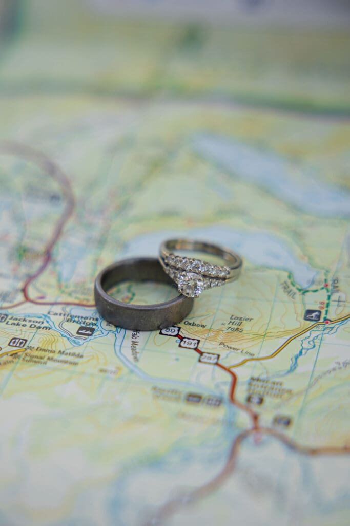 Wedding rings placed against a map of Jackson Hole, Wyoming