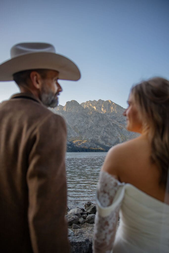 Bride and groom admire Jenny Lake at Grand Teton National Park
