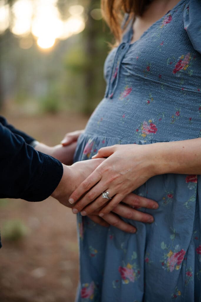 husband holds pregnant wife baby bump | Adair and Cody