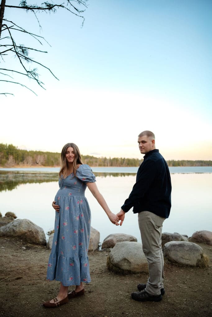 Pregnant wife leads husband on a trail at Itasca State Park