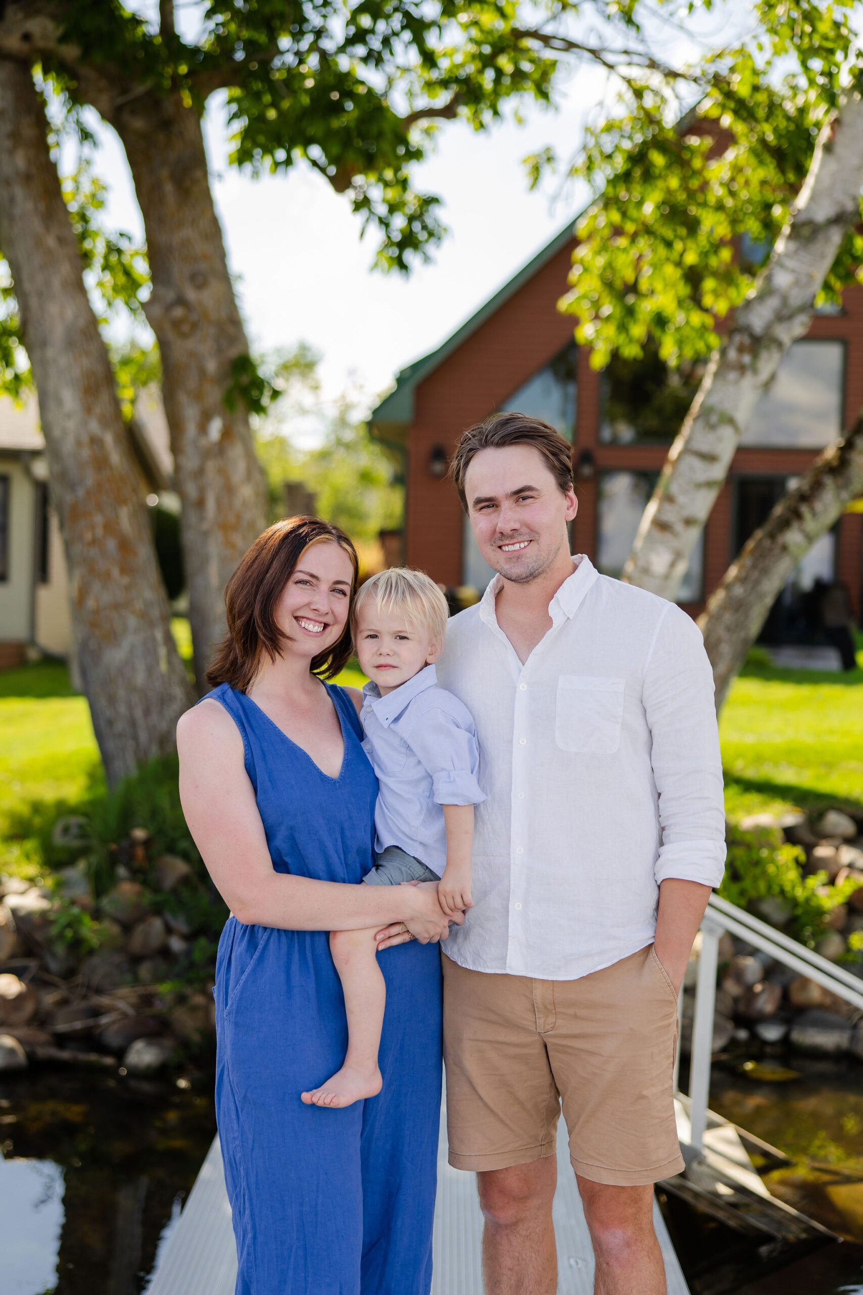 Family poses for photo in front of cabin