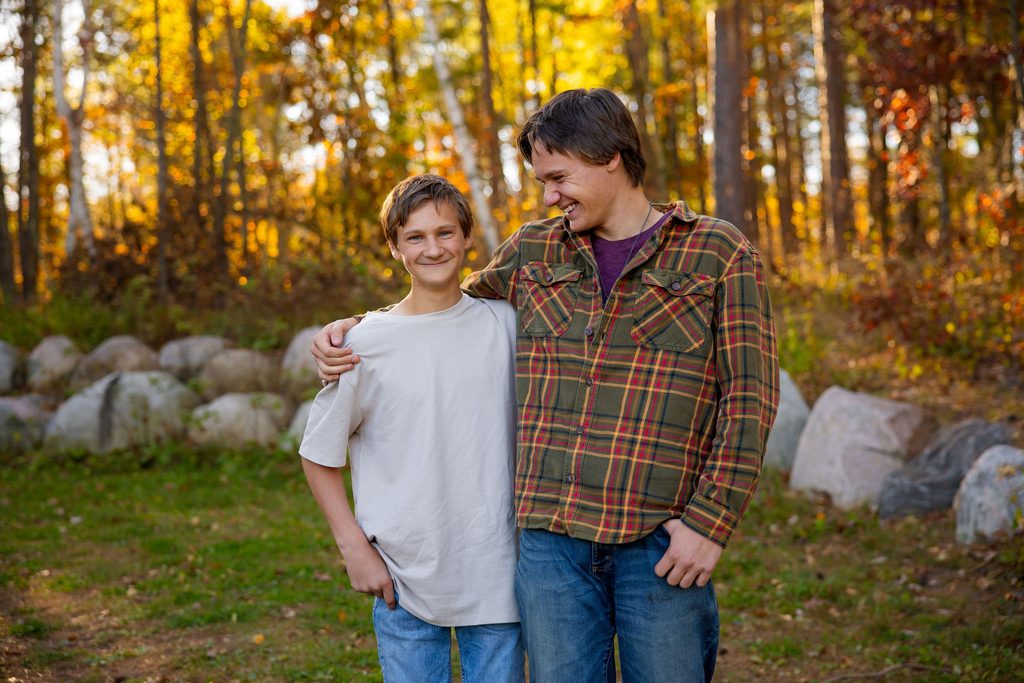 brothers share a laugh together while posing for the camera