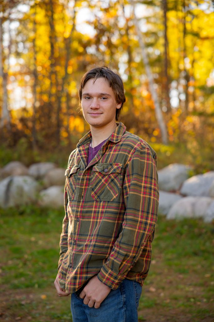 young man smiles at camera for solo portrait