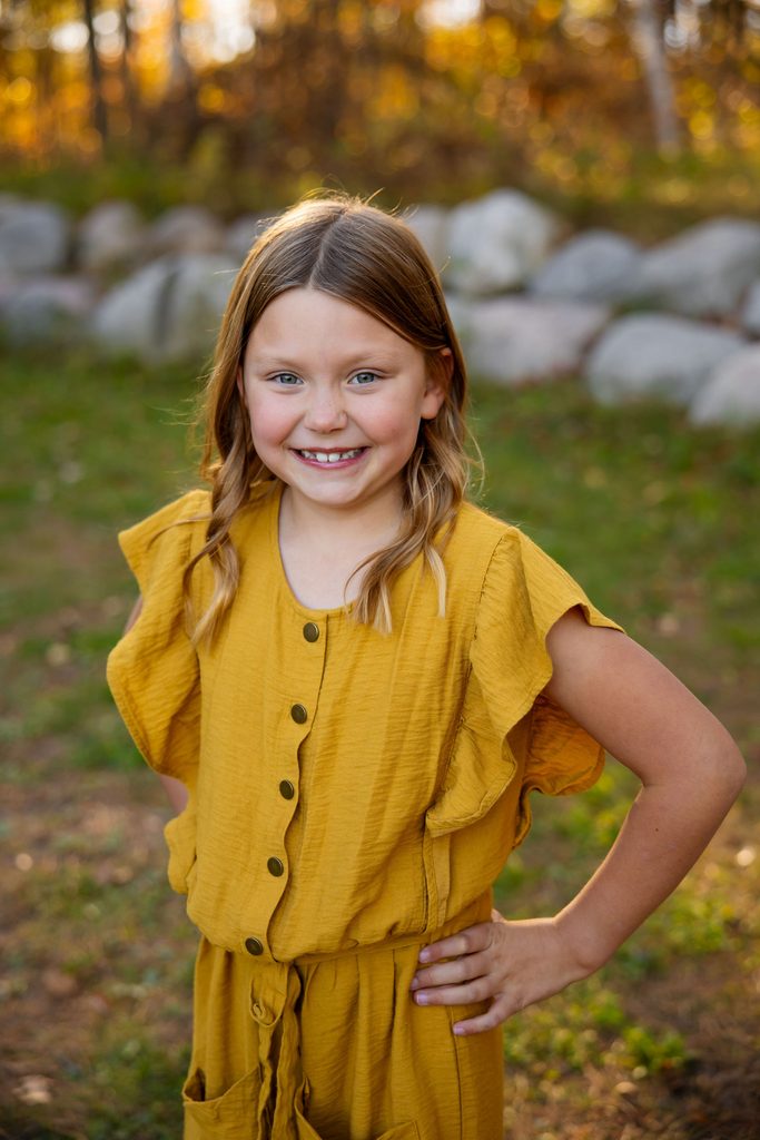 girl poses for fall family photos