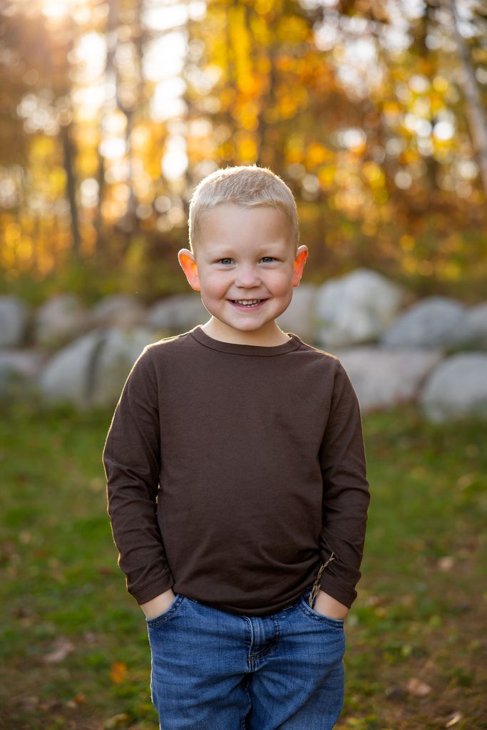 Little boy laughs at the camera