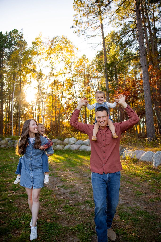 Mom and dad give piggy back rides for photos