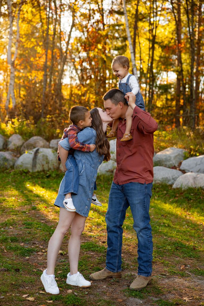 Mom and dad share a kiss while playing with children