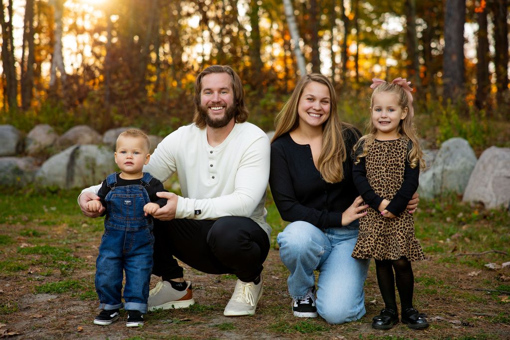 Family kneels together for family photos