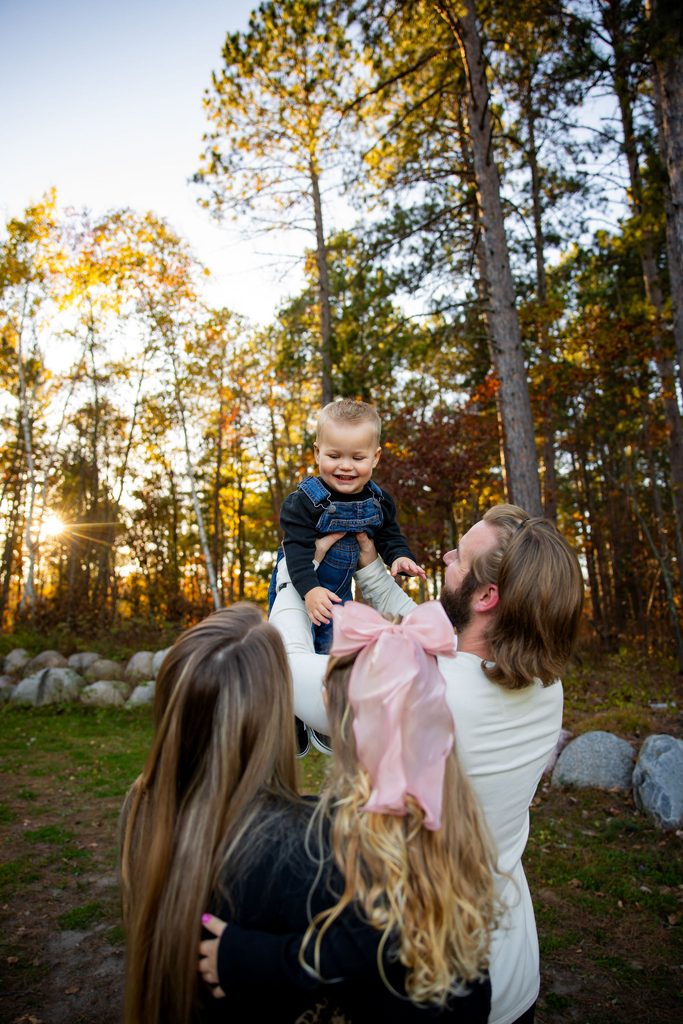Family plays at their fall family photo session