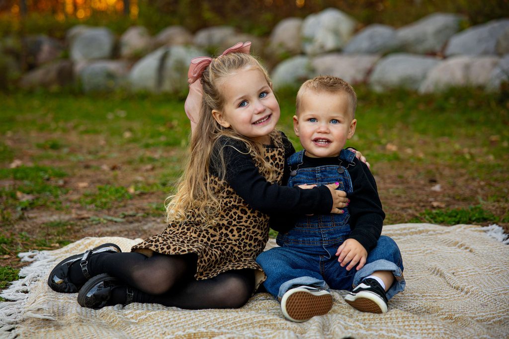 Sister hugs brother for photos