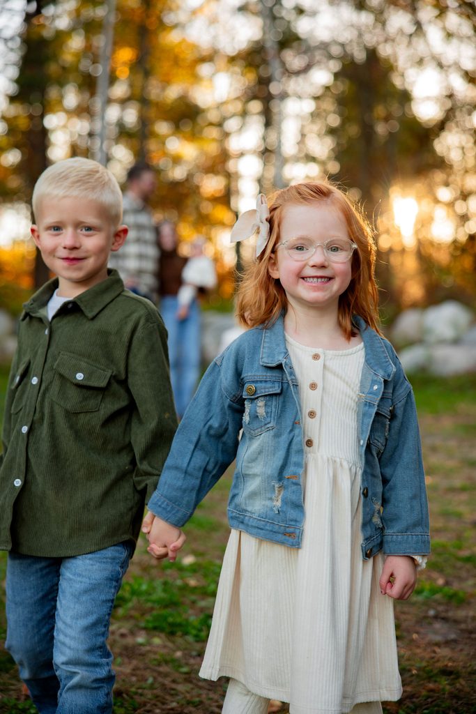 Sister leads her brother on a walk