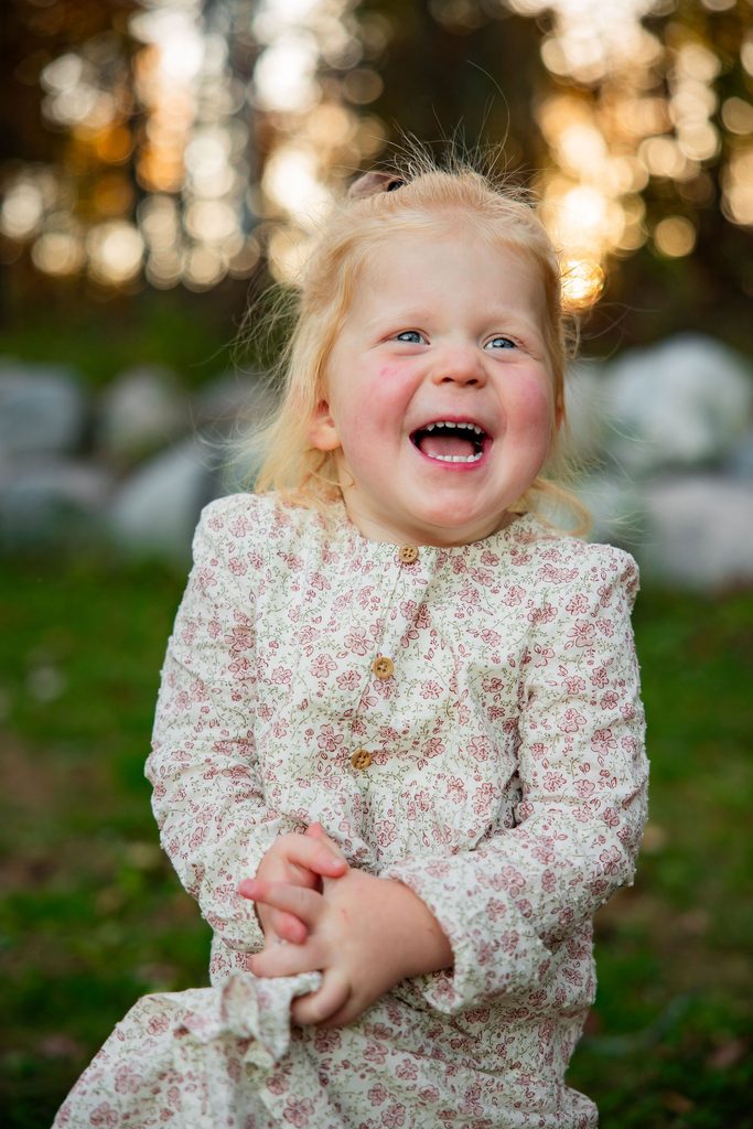 Little girl laughs during family photos