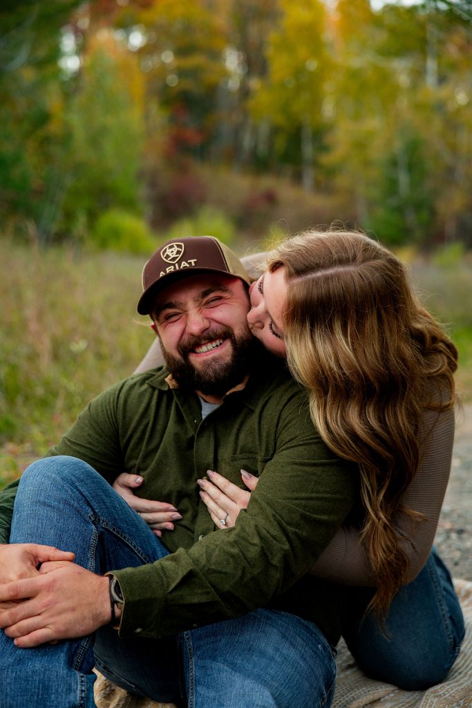 Women kisses fiance for engagement session