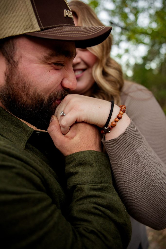 fiance kisses hand during engagement session