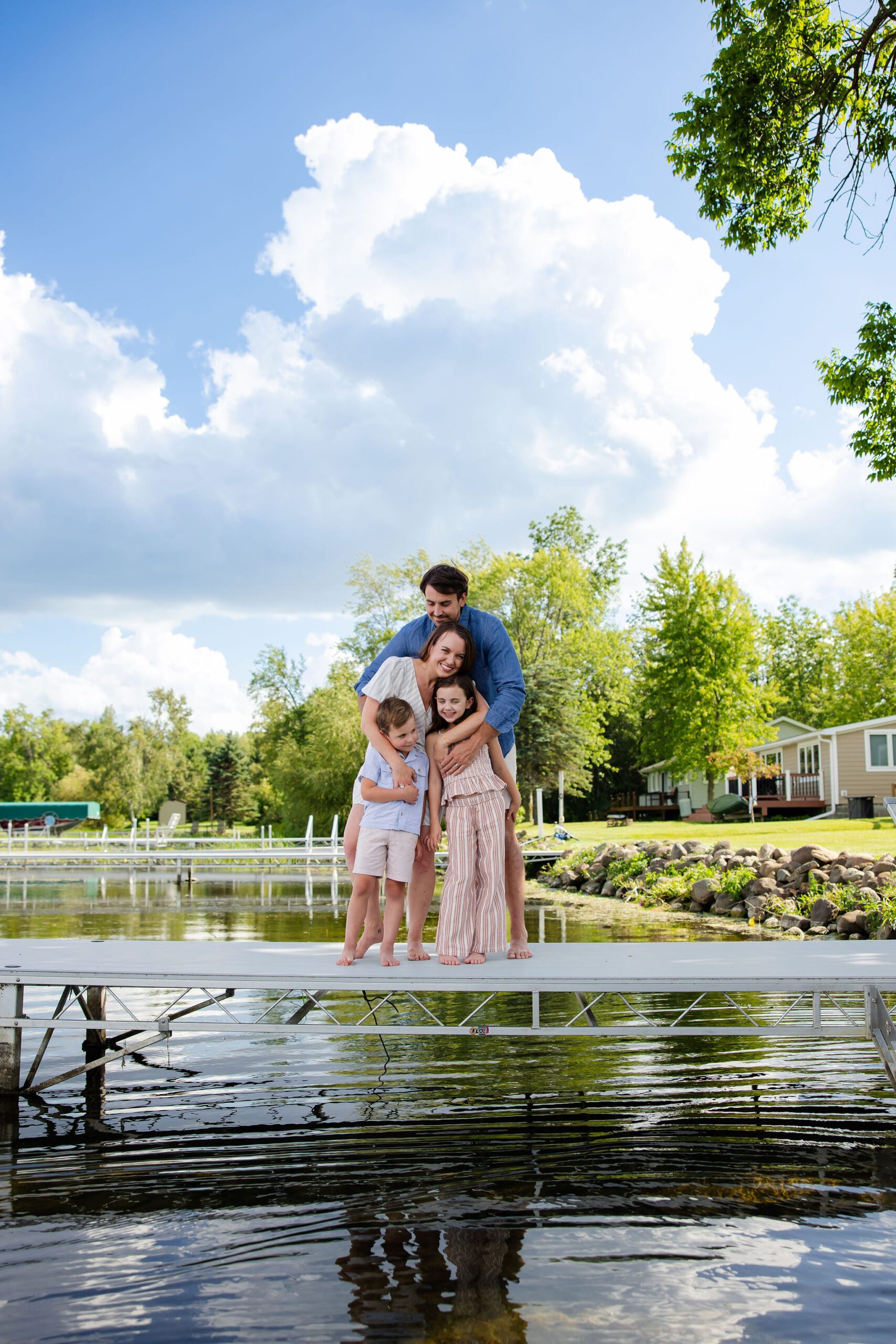 Family hugs in front of cabin