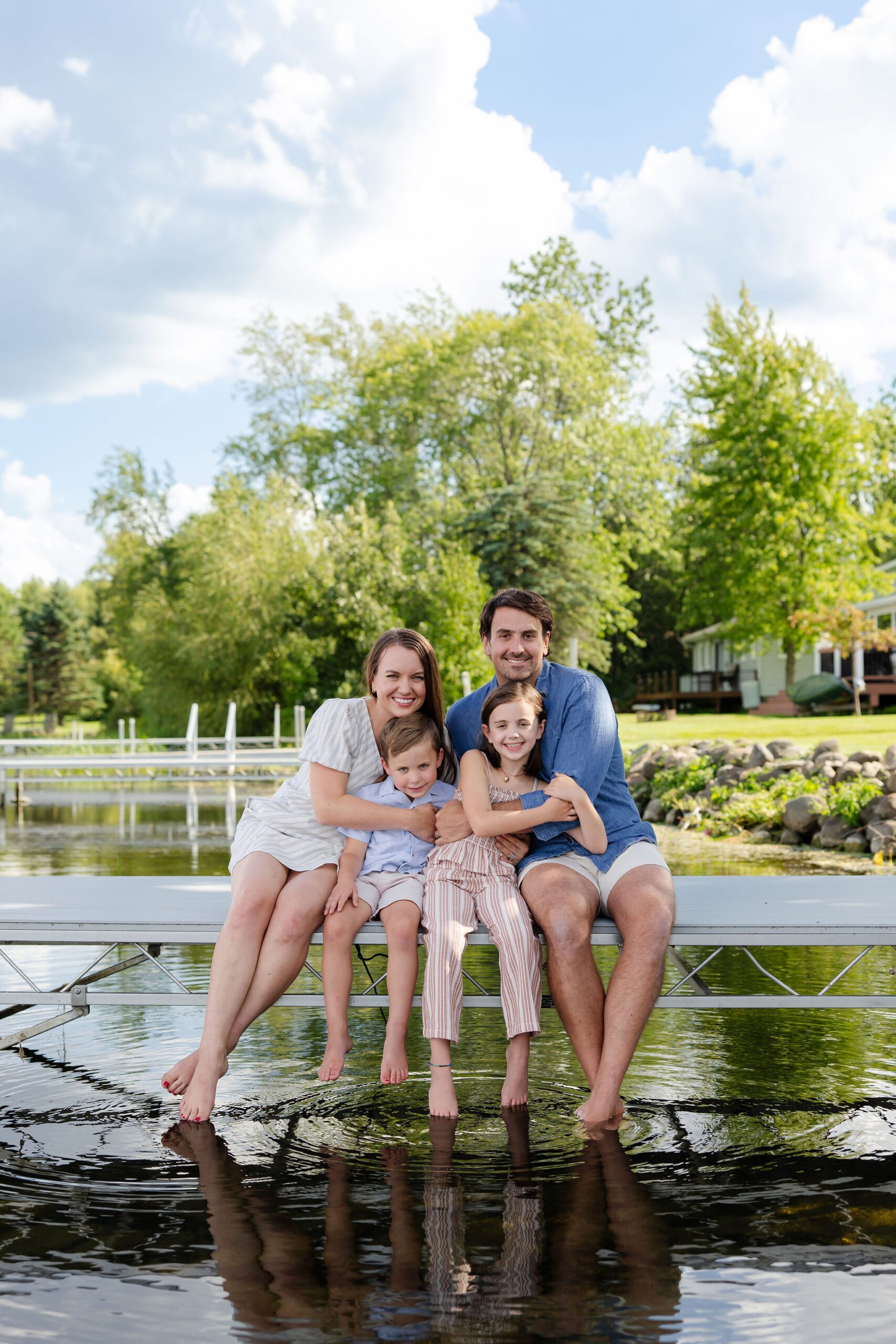 Family sits on Lake Bemidji Lakeside dock